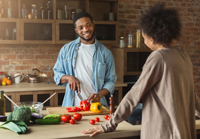 African American Couple Cooking in the Kitchen [Credit: Shuttrestock]