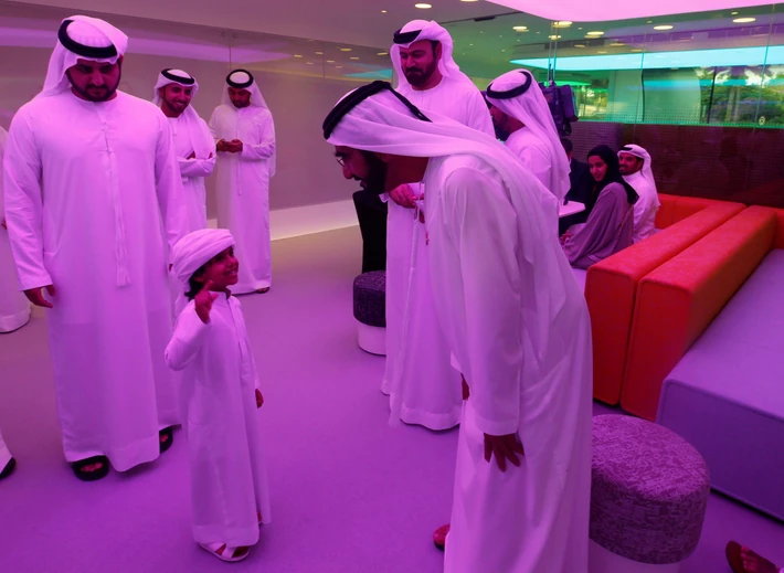 Sheikh Mohammed bin Rashid Al Maktoum talks with a child during the official opening ceremony of the