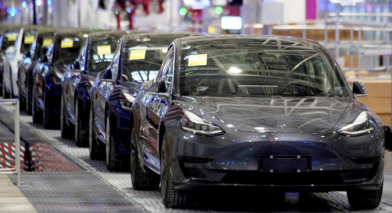 FILE PHOTO: Tesla China-made Model 3 vehicles are seen during a delivery event at its factory in Shanghai