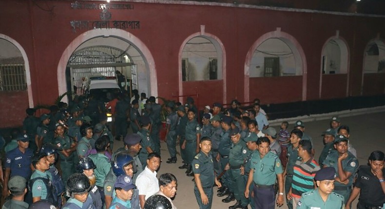 Bangladeshi prison security personnel stand guard in front of Khulna jail on October 16, 2016