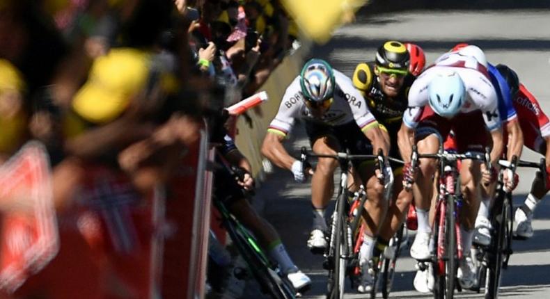 Slovakia's Peter Sagan (2nd L) flicks out an elbow as Britain's Mark Cavendish (L) falls near the finish line at the end of the 207.5 km fourth stage of the 104th Tour de France between Mondorf-les-Bains and Vittel on July 4, 2017