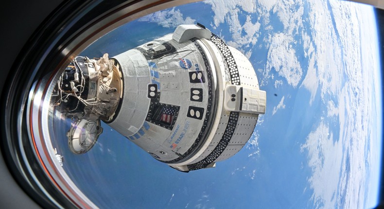 Boeing's Starliner spacecraft docked to the International Space Station, as seen from a window on a SpaceX Crew Dragon.NASA