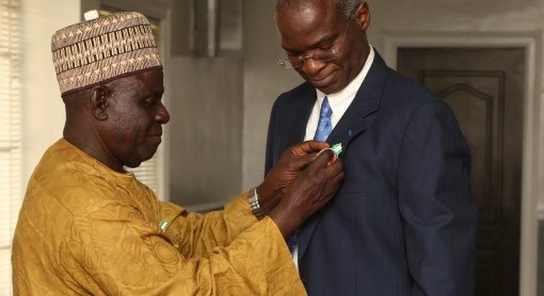 Minister of Power , Works and Housing , Mr Babatunde Fashola SAN (right) being decorated with the Armed Forces Remembrance Day Celebration Emblem 2016 by the National Chairman, Nigerian Legion, Colonel Micah Gaya (retd.) at the Honourable Minister’s Office, Ministry of Work’s Headquarters , Mabushi, Abuja, FCT on Wednesday, December 9, 2015.