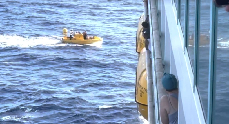 Passengers onboard Royal Caribbean's Mariner of the Sea watch as crew successfully rescue a woman who went overboard on Sunday.Courtesy of Matthew Kuhn