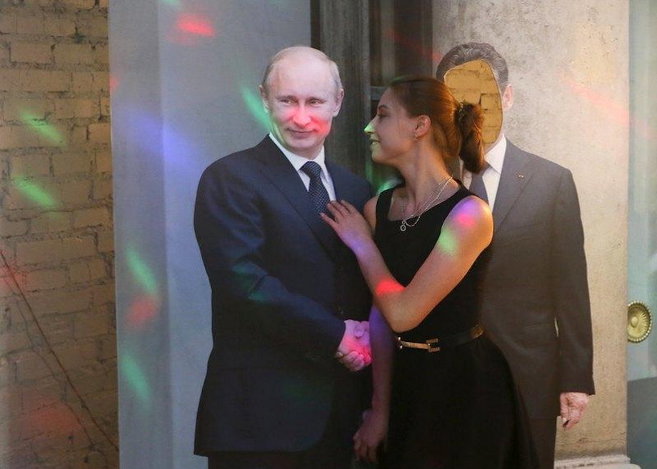 A woman poses with a cut-out of Vladimir Putin in the "President Cafe" in Krasnoyarsk, Siberia, Russia, April 7, 2016.