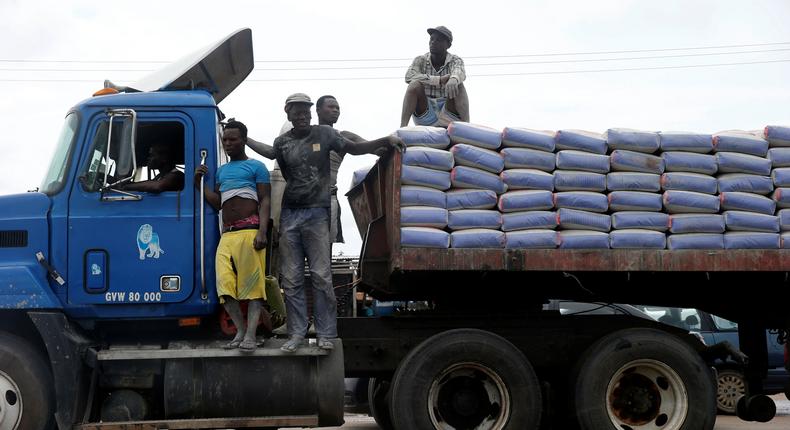 Labourers stand on top of a trailer transporting cement along Ajah-Lagos expressway in Nigeria's commercial capital Lagos, Nigeria June 3, 2017.