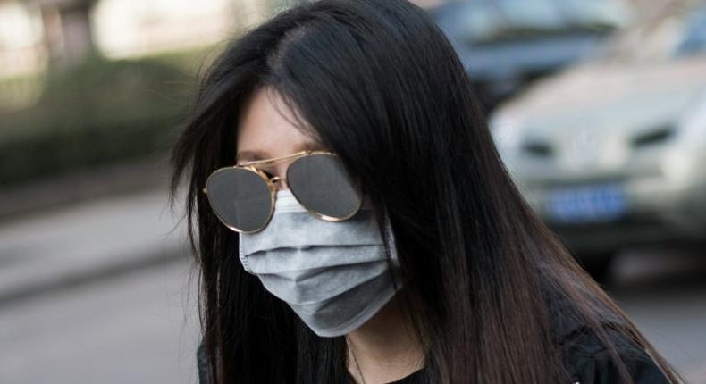 A woman wearing a face mask during a yellow alert for air pollution in Beijing on March 18, 2016