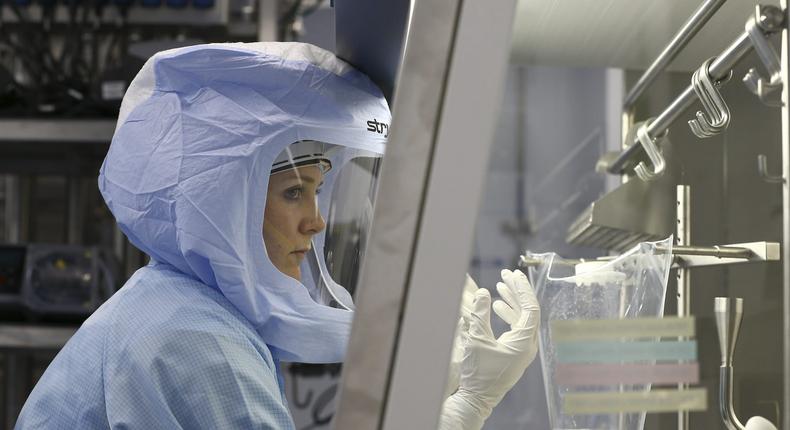 Employees in special suits test procedures for manufacturing the messenger RNA (mRNA) COVID-19 vaccine from Pfizer-BioNTech, in Marburg, Germany on March 29, 2021.
