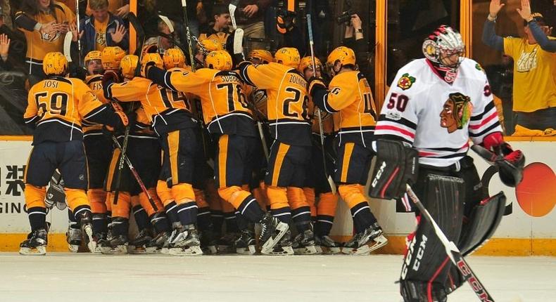 Kevin Fiala is swarmed by Nashville Predators teammates after scoring the game-winning overtime goal against the Chicago Blackhawks