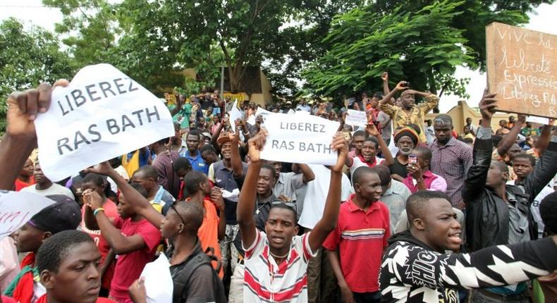 People hold signs reading Free Rasbath, referring to radio presenter Mohamed Youssouf Bathily, during a demonstration in front of Bamako's court on August 17, 2016.