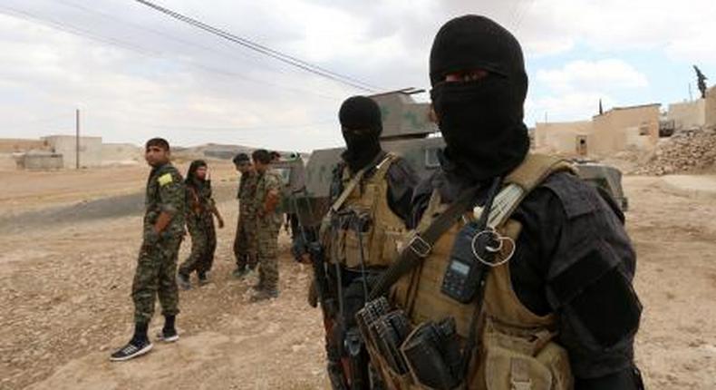 Special forces from the Syria Democratic Forces gather in Haj Hussein village, after taking control of it from Islamic State fighters, in the southern rural area of Manbij, in Aleppo Governorate, Syria May 31, 2016.