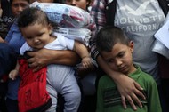 Children of undocumented immigrant families react as they are released from detention at a bus depot