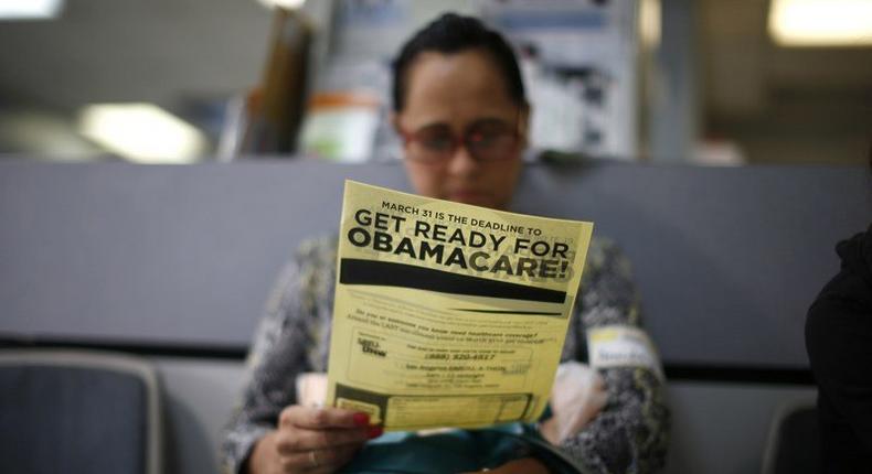 Arminda Murillo, 54, reads a leaflet on Obamacare at a health insurance enrollment event in Cudahy, California, U.S. March 27, 2014. REUTERS/Lucy Nicholson/File Photo