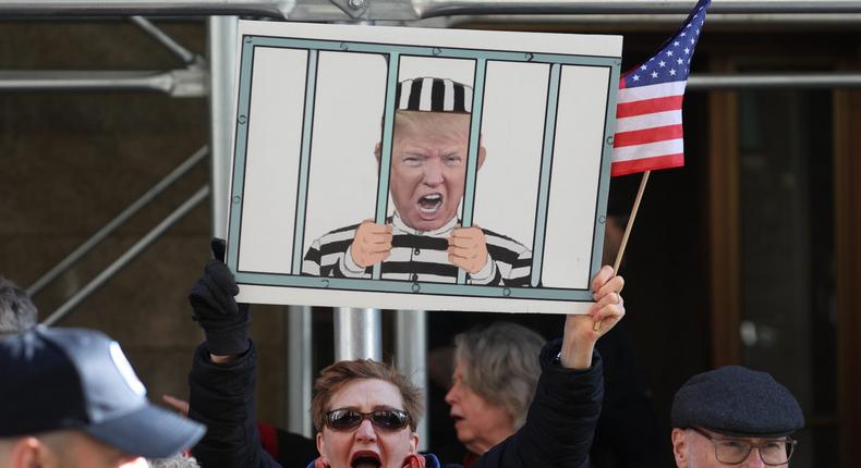 Demonstrators gathered outside of Manhattan Criminal Court while a grand jury was presented with evidence in a case against Donald Trump.Scott Olson/Getty Images