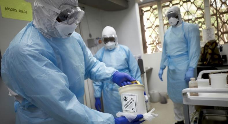 Mali, mired in an eight-year-old conflict, said two nationals who had returned from France tested positive for the virus. Here, a Malian researcher holds a sample to be tested at a research center in Bamako