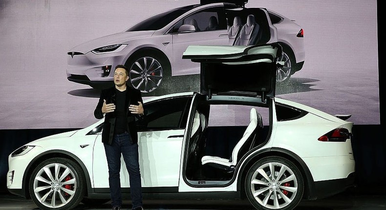 Elon Musk in front of a TeslaGetty