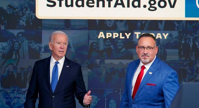 President Joe Biden, left, answers questions with Education Secretary Miguel Cardona as they leave an event about the administration's student-loan forgiveness plan at the White House on October 17, 2022.AP Photo/Susan Walsh