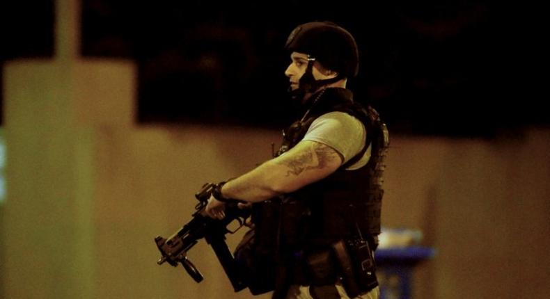 An armed police officer at the scene in the Melbourne bayside suburb of Brighton on June 5, 2017, after a woman was held against her will in an apartment block