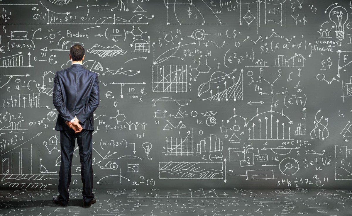 Mężczyzna przed zapisaną tablicą