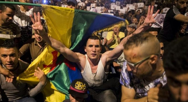 Protestors hold berber flags during a demonstration against corruption, repression and unemployment in Morocco's northern city of al-Hoceima on May 30, 2017