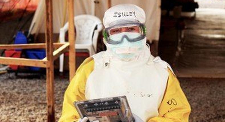 health care worker holding Ebola proof tablet