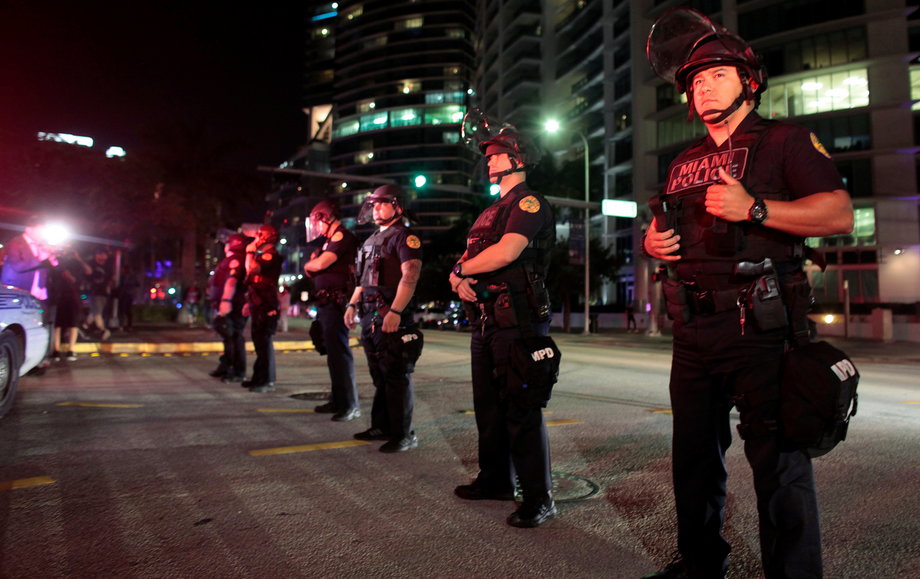 Police officers stand guard during a protest against U.S. President-elect Donald Trump in Miami, Florida, U.S. November 11, 2016.