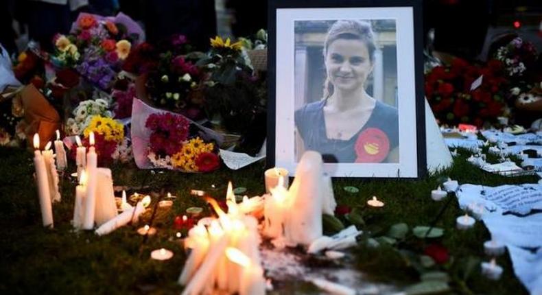 Mourners leave candles in memory of murdered Labour Party MP Jo Cox, who was shot dead in Birstall, during a vigil at Parliament Square in London, Britain June 17, 2016.