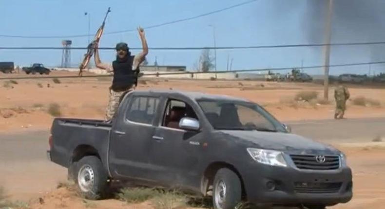 A still image from video released May 17, 2016 shows forces loyal to Libyan unity government celebrating the recapture of Abu Grain, one of the main checkpoints south of the city of Misrata, Libya from Islamic State. 