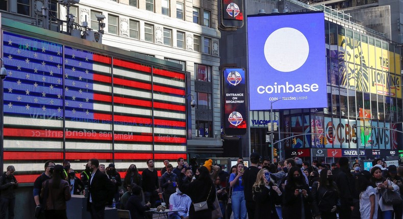 Coinbase Global watch as their listing is displayed on the Nasdaq MarketSite at Times Square in New York on April 14, 2021.