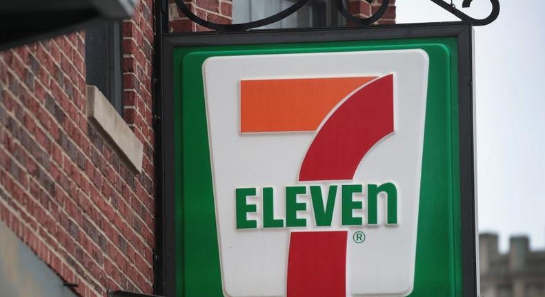 A 7-Eleven sign hangs outside a building.