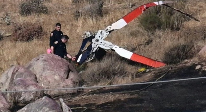 Investigators walk around rotor blades from one of the crashed helicopters on a burned hillside in Cabazon, California.Patrick T. Fallon/AFP via Getty Images