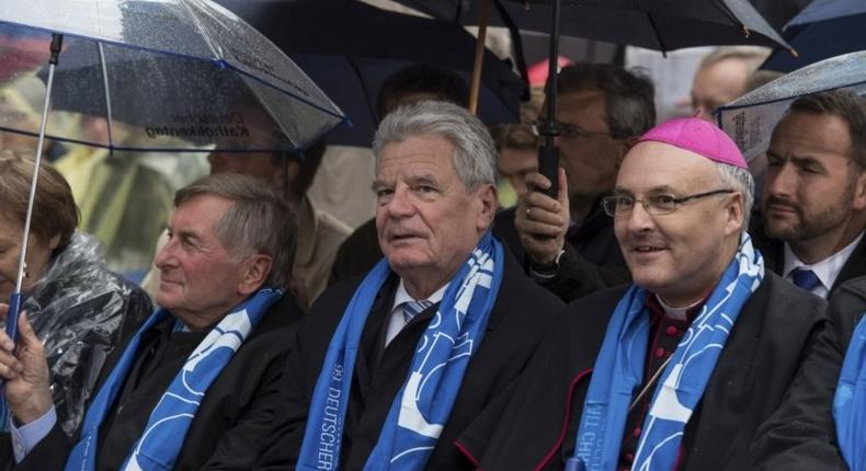 Alois Glueck, head of the lay Central Committee of German Catholics, is pictured with Germany's President Joachim Gauck (C) and Bishop Rudolf Voderholzer of Regensburg.