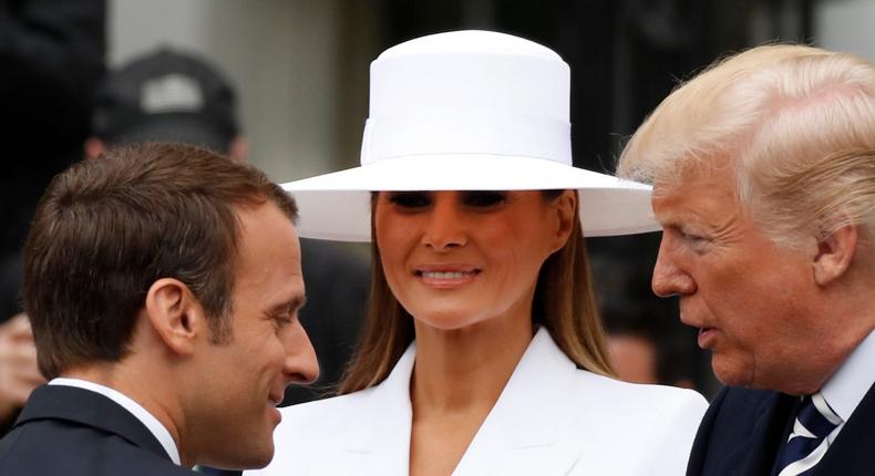 Former first lady Melania Trump (center) wearing a white Herv Pierre hat with French President Emmanuel Macron and former President Donald Trump in Washington, DC.