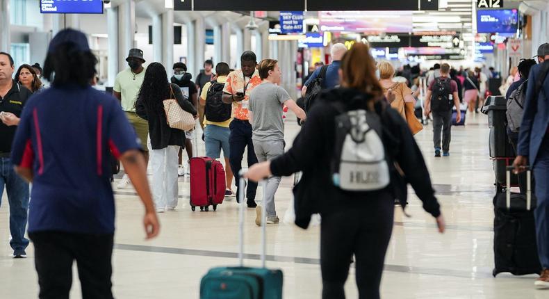 Passengers traverse a concourse at Hartsfield-Jackson Atlanta International Airport ahead of the Fourth of July holiday in Atlanta, Georgia, on July 1, 2022.