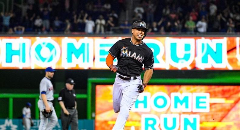 Giancarlo Stanton of the Miami Marlins hits the go ahead homerun in the eighth inning during their game against the New York Mets, at Marlins Park in Miami, Florida, on April 15, 2017