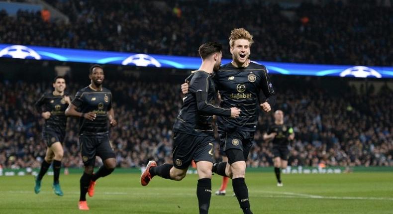 Celtic's Patrick Roberts (C) celebrates scoring a goal with teammate Stuart Armstrong during a UEFA Champions League match in Manchester, on December 6, 2016