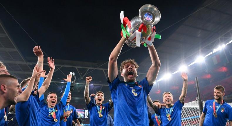 Italy midfielder Manuel Locatelli holding the Euro 2020 trophy. Creator: Laurence Griffiths