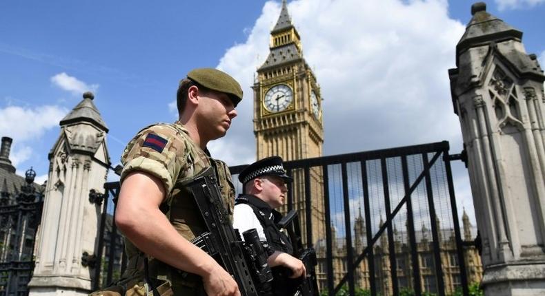 A British soldier and armed police officer patrol near the Houses of Parliament in central London on May 24, 2017