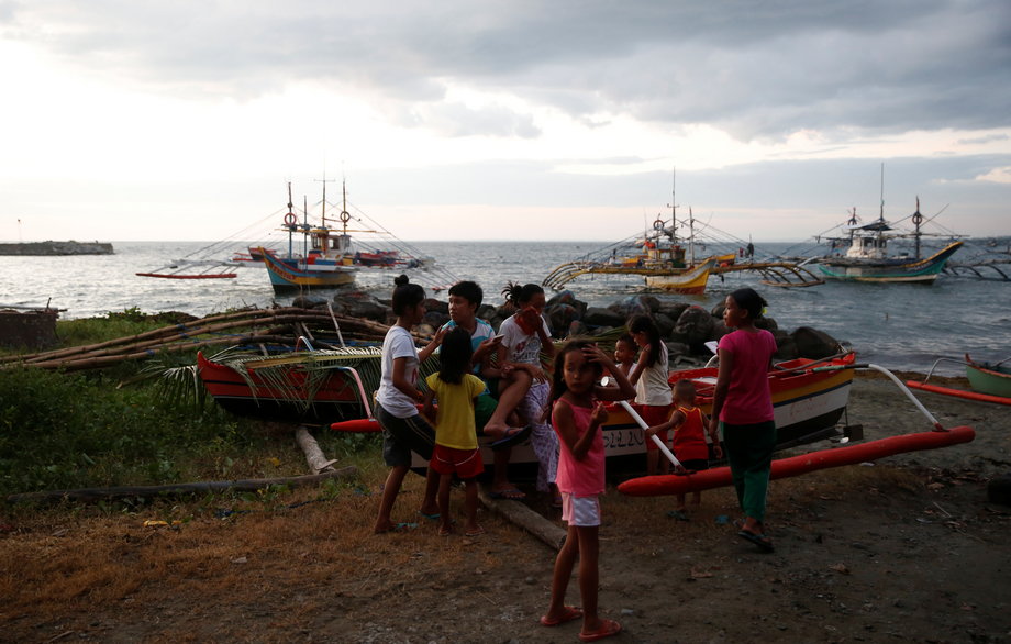 Residents gather near fishing boats that just returned from disputed Scarborough Shoal, as they are docked at the coastal village of Cato in Infanta, Pangasinan in the Philippines, October 31, 2016.