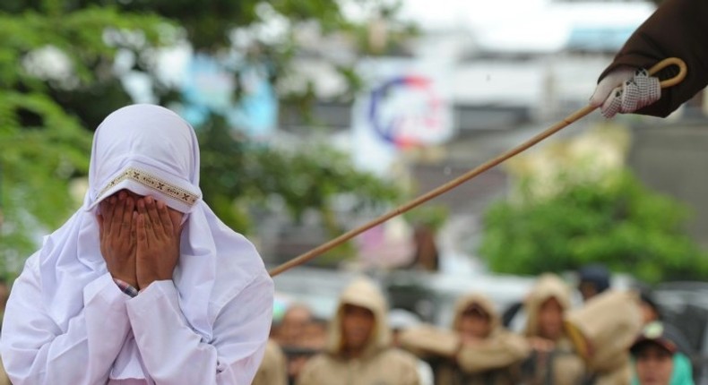 A Muslim woman is caned in Banda Aceh, Indonesia, on October 17, 2016