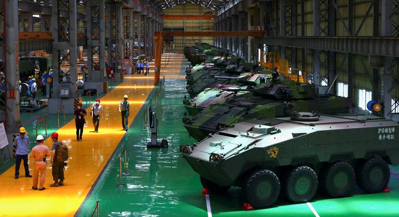 Staff members work on the production line of Taiwan military's latest armoured vehicle the CM-34 Clouded Leopard in Nantou