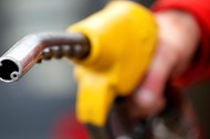 FILE PHOTO: An attendant prepares to refuel a car at a petrol station in Rome