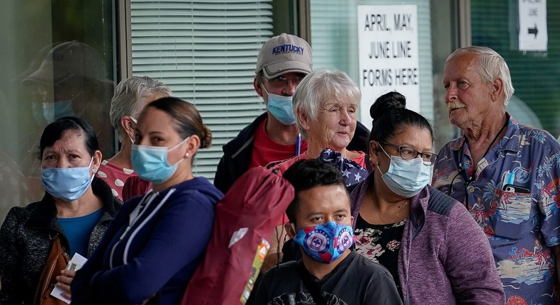 FILE PHOTO: People line up outside a Kentucky Career Center hoping to find assistance with their unemployment claim in Frankfort