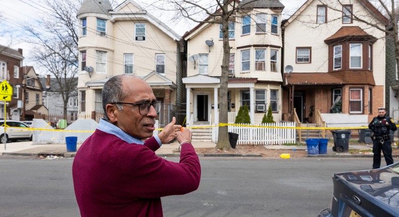 Newark City employee Sushil Nagpal stands outside homes that were damaged and had to be evacuated after the earthquake on Friday,Spencer Platt/Getty Images