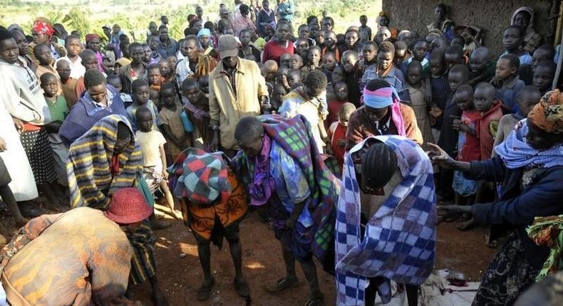 A fiile photo of people gathered around teenage girls who have just undergone female genital mutilation. REUTERS/James Akena