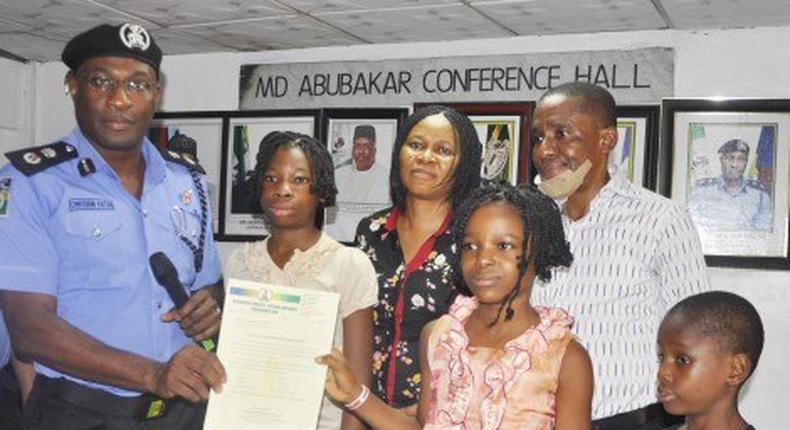 Mr. Owoseni Fatai, presenting the scholarship to the 4 children of the late Mrs Idongesit Ekpo