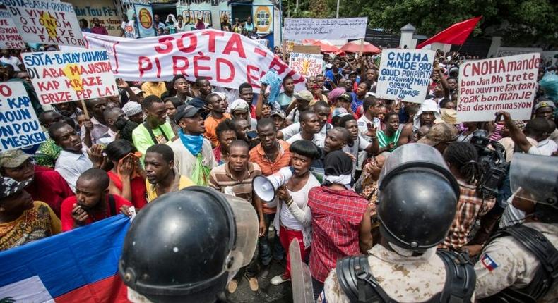 Workers demonstrate in front of Haiti's Ministry of Social Affairs and Labor in Port-au-Prince on July 10, 2017, to demand a raise in the minimum wage