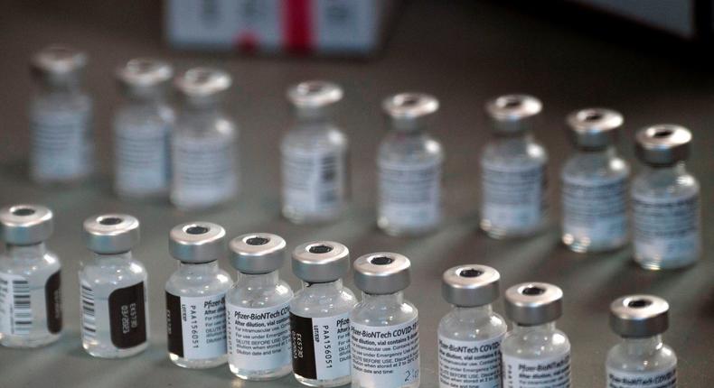 vials of the Pfizer-BioNTech Covid-19 vaccine are prepared to be administered to front-line health care workers under an emergency use authorization at a drive up vaccination site from Renown Health in Reno, Nevada on December 17, 2020.
