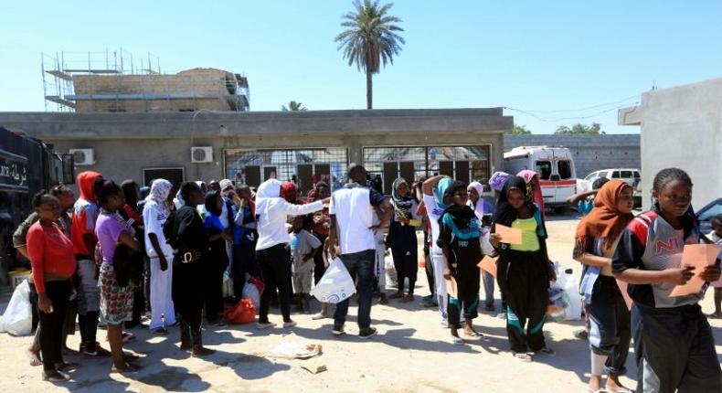 African migrants gather at a centre in the Libyan capital on August 17, 2017 ahead of being repatriated to their country of origin under a voluntary programme coordinated by the International Organization for Migration (IOM)