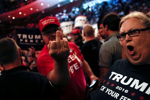 Supporters of Republican U.S. presidential nominee Donald Trump scream and gesture at members of the